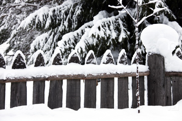 The fence in the snow. Snow fence in the village. Karelia, Russia