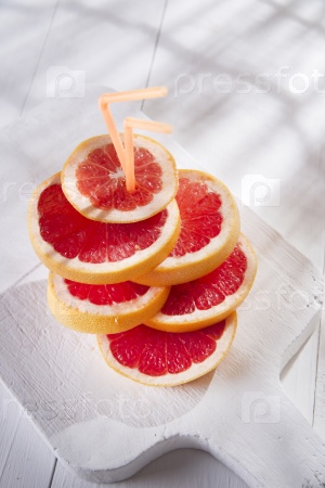 Aperitif with slices of red grapefruit on white-border