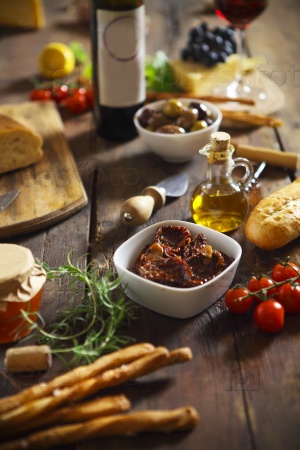 Italian food ingredients with red wine on wooden background