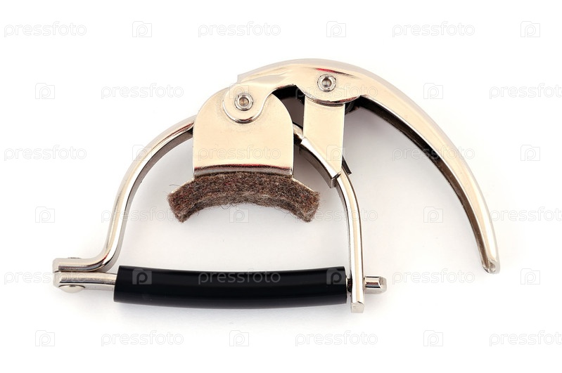 Фотография на тему Металлический каподастр на белом фоне | PressFoto