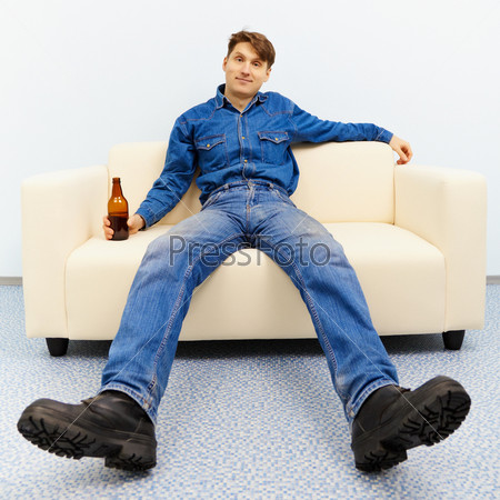 Мужик лежит на диване с пивом