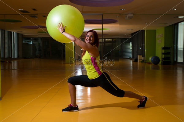 Women stretching with fitness balls.