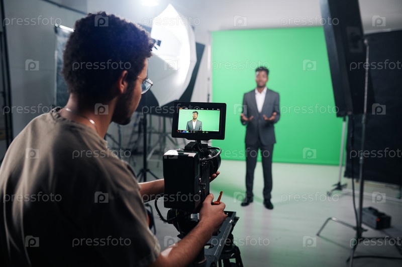 Cameraman using camera to shoot TV program