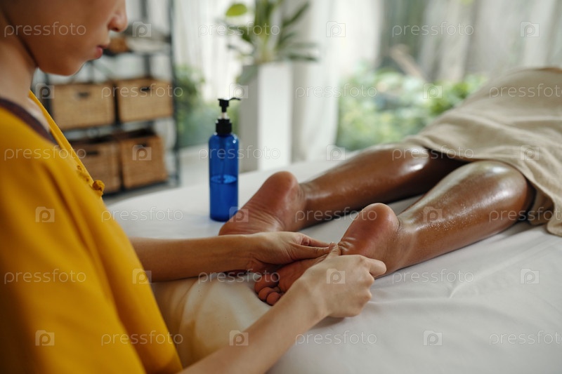 Massaging Legs in Relaxing Spa Environment