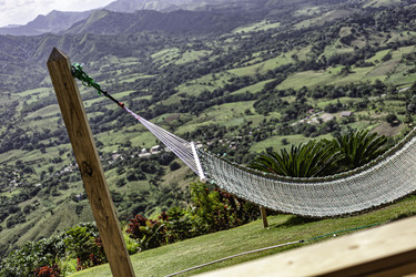 Empty hammock overlooking tropical green valley in montaña redonda, dominican republic - Pippocarlot