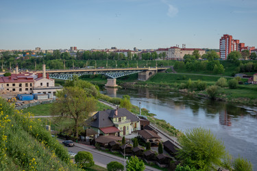 Гродно, Беларусь - 1 мая 2025 года: Городская улица. Городской пейзаж под ярко-голубым небом - steveee