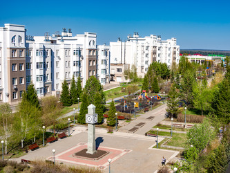 Часовая башня, расположенная в центре жилой площади в пригороде Лесная Поляна города Кемерово, в окружении многоквартирных домов, зеленых зон и детской площадки. Выборочная фокусировка - dkorostilev78