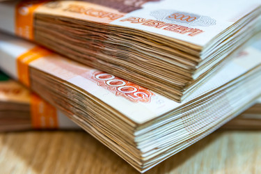 Красные купюры номиналом 5000 долларов лежат на светлой поверхности, выборочная фокусировка и крупный план - dkorostilev78