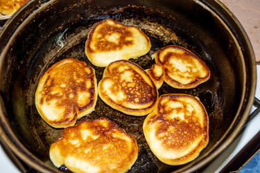 Вкусные блинчики жарятся на черной сковороде, источая аромат свежей выпечки, напоминающий о старом доме и бабушке - dkorostilev78