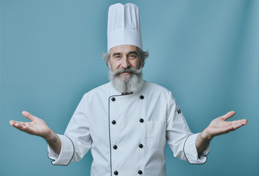 Портрет шеф-повара высшего звена, представляющего концепцию кулинарного обслуживания. - SeventyFour