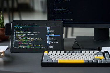 Рабочее пространство разработчика: отображение кода на планшете для разработки программного обеспечения. - Pressmaster