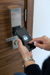 Adult Woman Unlocking Smart Door with Smartphone for Home Access - DragonImagesAsia