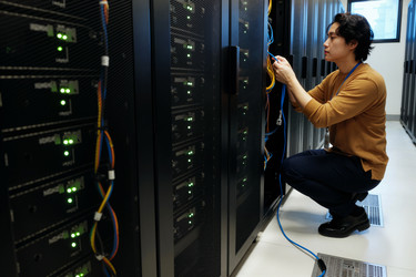 Азиат настраивает серверную стойку для обслуживания центра обработки данных - DragonImagesAsia