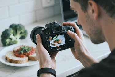Взрослый мужчина фотографирует еду для маркетингового контента ресторана - Mediaphotos