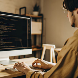 Молодой программист усердно работает над компьютерным проектом. Генеративный искусственный интеллект - RomanZ
