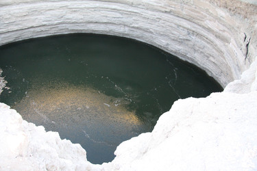 Карстовая воронка Дарваза с изумрудной водой в пустыне Каракум, Туркменистан, под ясным голубым небом - EOS_Canon