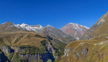 Mountain landscape near Gudauri from Georgia-Russia Friendship Monument, Georgia. Sunny day with bright blue skyм - borisb17