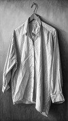 Смятая рубашка, висящая на вешалке на фактурном фоне. Генеративный ИИ - RomanZ