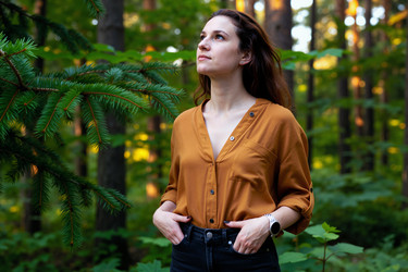 Взрослая женщина, стоящая в лесу за брендинг nature wellness - Mediaphotos