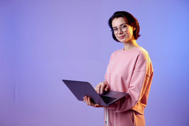Портрет улыбающейся женщины с ноутбуком в руках для удаленной работы - Pressmaster
