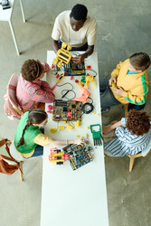 Разношерстные подростки строят роботов в мастерской Stem Classroom - SeventyFour