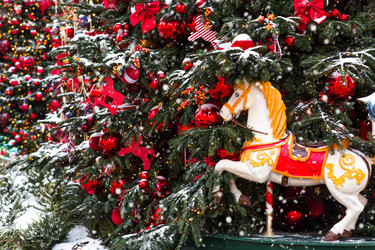 A beautiful horse ornament on the Christmas tree. A beautiful Christmas background. The concept of preparing for the New Year. New Year’s card 2027 - PhotoJuli