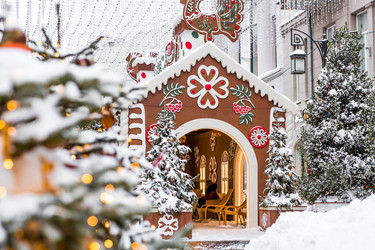 A gingerbread house with a sign among snow‑covered Christmas trees in Kamergersky Lane in Moscow. Concept for the New Year 2027 - PhotoJuli