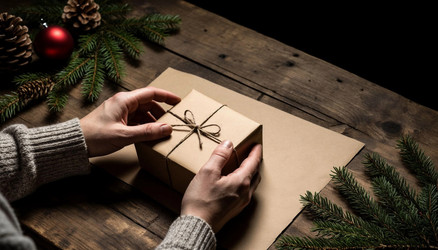 Hands Holding Kraft Paper Gift Box Top View – Christmas Holiday Present for Eco Friendly Wrapping, DIY Gift Tag or Cozy Winter Content - Kulkann75