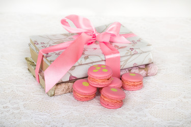 Rose cookies with cream on table with books wrapped ribbon - paha_l
