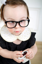 Portrait of serious little girl in black dress and glasses - paha_l