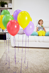 Little girl sits on big sofa in room with light carpet on - paha_l