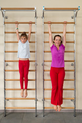 Mother and daughter hanging on a horizontal bar in a gym - paha_l