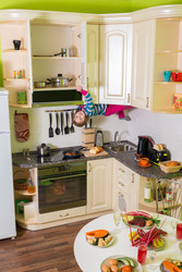 Little girl upside down holds a shelves in the kitchen with - paha_l