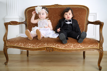 Little girl in beautiful white dress and serious boy in - paha_l