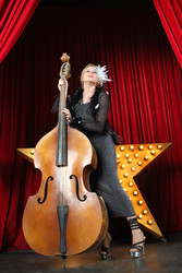 Portrait of a beautiful girl contrabass on stage at music hall - paha_l
