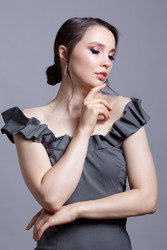 Portrait of young woman in gray dress on grеy background - Serg Zastavkin