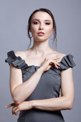 Portrait of young woman in gray dress on grеy background - Serg Zastavkin