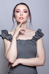 Portrait of young woman in gray dress on grеy background - Serg Zastavkin