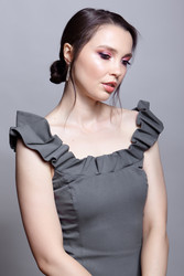 Portrait of young woman in gray dress on grеy background - Serg Zastavkin