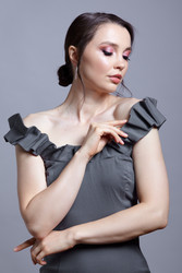 Portrait of young woman in gray dress on grеy background - Serg Zastavkin