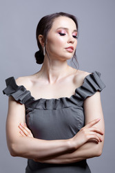Portrait of young woman in gray dress on grеy background - Serg Zastavkin