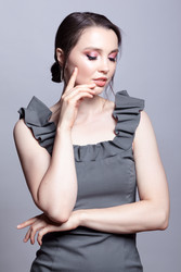 Portrait of young woman in gray dress on grеy background - Serg Zastavkin