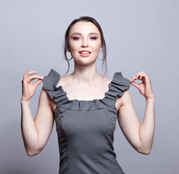 Portrait of young woman in gray dress on grеy background - Serg Zastavkin