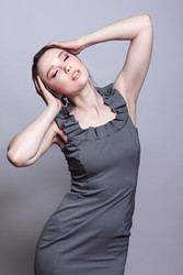 Portrait of young woman in gray dress on grеy background - Serg Zastavkin