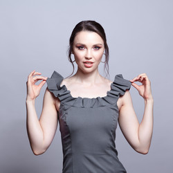 Portrait of young woman in gray dress on grеy background - Serg Zastavkin