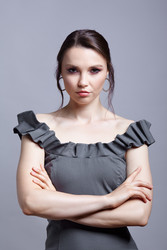 Portrait of young woman in gray dress on grеy background - Serg Zastavkin