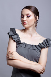 Portrait of young woman in gray dress on grеy background - Serg Zastavkin