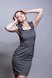 Portrait of young woman in gray dress on grеy background - Serg Zastavkin