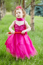 Little girl dressed in bright puffy gown stands on grassy - paha_l