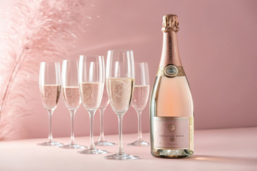 Celebrate With Sparkling Rosé Champagne and Elegant Flutes on a Pink Background - RomanZ